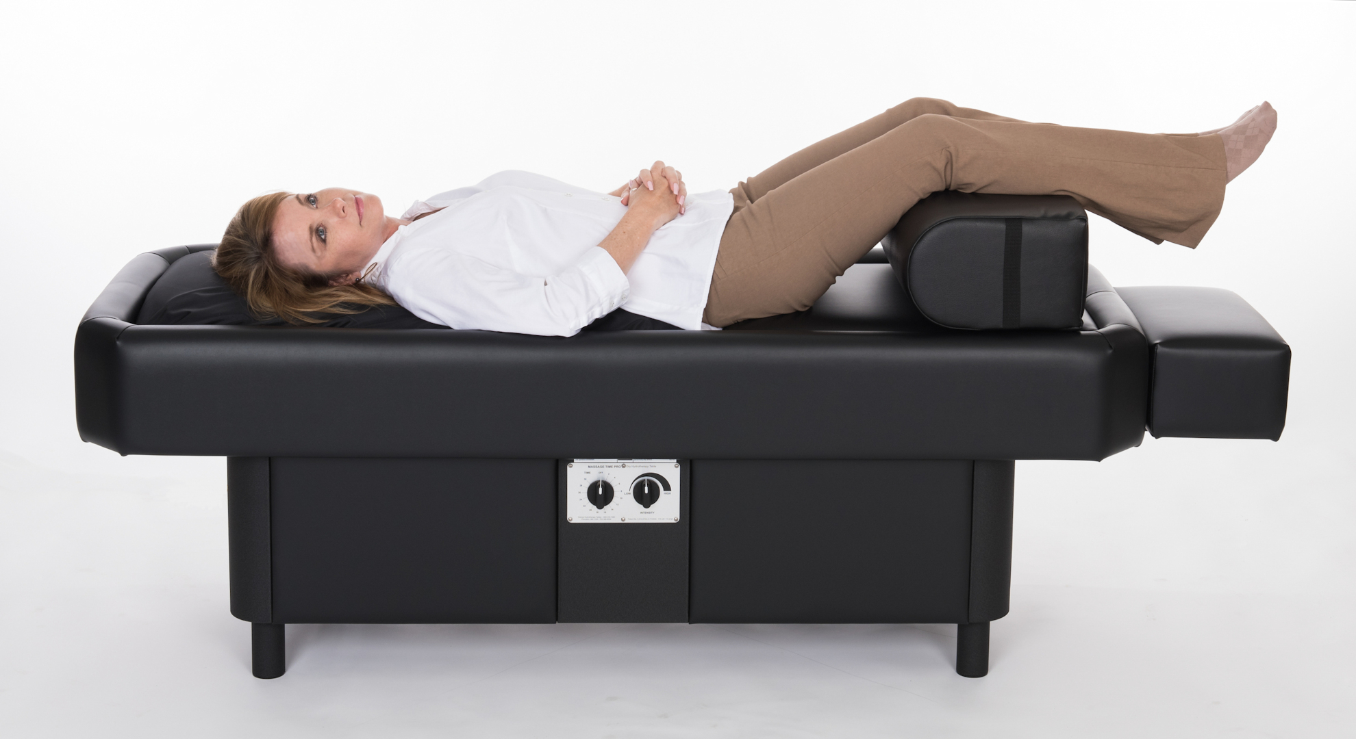 lady on hydromassage table with leg bolster laying on the side
